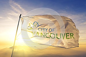 Vancouver of British Columbia of Canada flag waving on the top sunrise mist fog