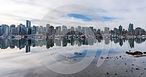 Vancouver City skyline reflected on the water surface. Beautiful cityscape seen from Stanley Park.