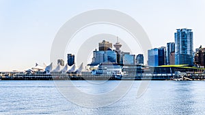 Vancouver Downtown Skyline and Harbor with the sails of the Cruise Terminal building on the left.