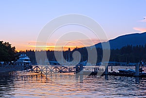 Vancouver Harbor with moored vessels at sunset, Vancouver BC, Canada.