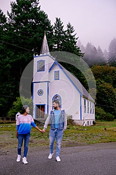Vancouver Island, Canada, Quadra Island old historical church by the harbor at Cape Mudge , couple on vacation at