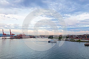 Vancouver skyline with container port terminal at sunset, British Columbia, Canada.