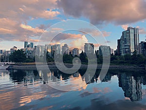 Vancouver skyline during pink cloudy sunset reflected in the lake