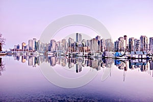 Vancouver skyline and reflection in water.