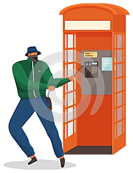 Vandal damaging the telephone booth isolated on white. Bandit in mask destroy city property