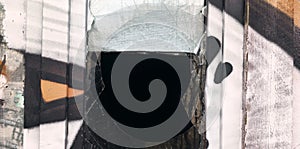 Vandal-smashed glass and traces of graffiti paint