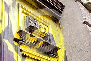 Vandalised, spray painted antique old wooden door detail, destroyed dated architecture, vandalism, building sprayed with paint