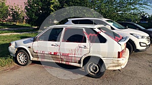 Vandalism - a modern car, doused with paint in free parking photo