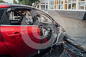 Vandalism or revenge, burnt car. The consequences of popular protest, burnt car, a crime. Car after fire. Auto trash