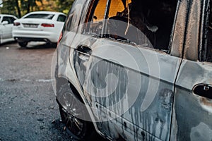 Vandalism or revenge, burnt car. The consequences of popular protest, burnt car, a crime. Car after fire. Auto trash