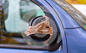 Vandalism on the wing mirror of a car