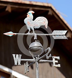 vane with a metal rooster indicating  the wind direction