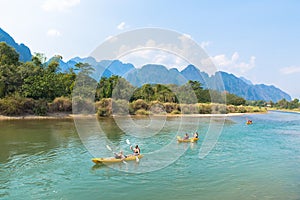 Vang Vieng, Laos - February 17, 2017: Tourists kayaking at Nam S