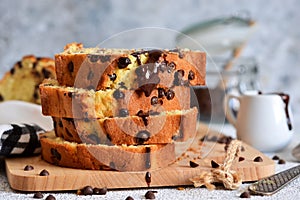 Vanilla bread with chocolate drops on the kitchen table. Slices of cake