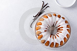 Vanilla bundt cake drizzled with powder sugar glaze