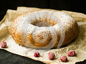 Vanilla bundt cake with fresh raspberries on a black table. vegetarian, lean, dairy and egg free. Selective focus. Close