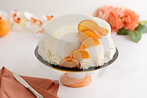 Vanilla cake with orange and napkin