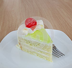 Vanilla cake slice and fresh cherry