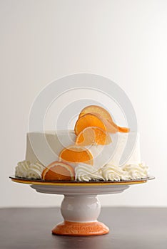 Vanilla cake with white frosting and orange slices