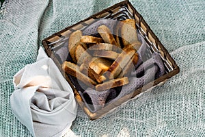 Vanilla crackers for tea, simple sweet crunchy snack in a wicker basket on natural fabric