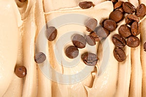 Vanilla creamy ice cream flavored with roasted coffee beans, to be served as a frozen tasty dessert.