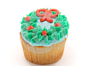 Vanilla cupcake with green blue and orange icing