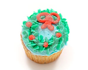 Vanilla cupcake with green blue and orange icing