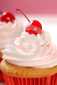 Vanilla cupcake with maraschino cherry