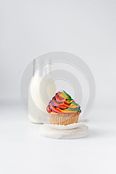 Vanilla cupcake with rainbow frosting on plate