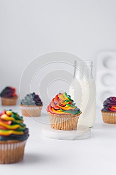 Vanilla cupcake with rainbow frosting on plate