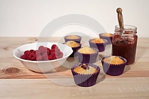 Vanilla cupcakes filled with jam and raspberry