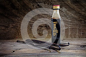 Vanilla extract, homemade in a small bottle and vanilla beans on