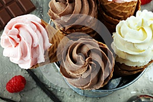 Vanilla frozen yogurt or soft ice cream in waffle cone.