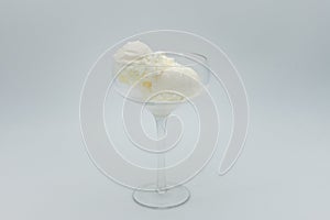 Vanilla ice cream without any topping in glass on white background.