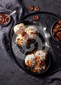 Vanilla ice cream with caramel sauce and pecan nuts