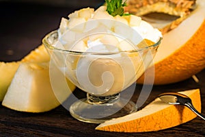 Vanilla ice cream with pieces of fresh melon close