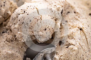 Speciality Italian stracciatella ice cream scoop with flakes of dark chocolate in a creamy vanilla ice-cream viewed from
