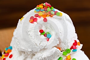 Vanilla ice cream scoop swith sprinkles, close up