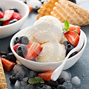 Vanilla ice cream scoops with berries