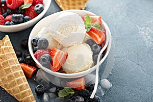 Vanilla ice cream scoops with berries