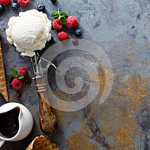 Vanilla ice cream scoops in a bowl with fresh berries