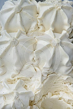 Vanilla ice cream stored in a display case, a classic and versatile frozen desert with a smooth and creamy texture