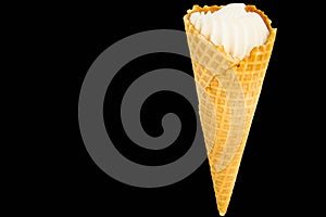 Vanilla ice cream in a waffle cone and black copy space with a saved clipping path, isolated