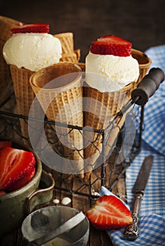 Vanilla Ice Cream in a waffle cones with strawberries