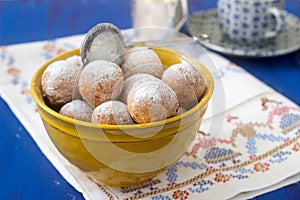 Vanilla krapfen doghnut with coffee. Rustic style.