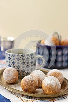 Vanilla krapfen doghnut with coffee. Rustic style.