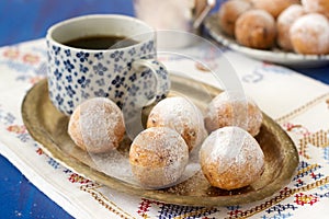 Vanilla krapfen doghnut with coffee. Rustic style.