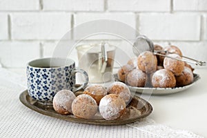 Vanilla krapfen doghnut with coffee. Rustic style.