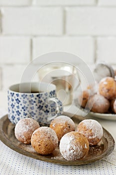 Vanilla krapfen doghnut with coffee. Rustic style.