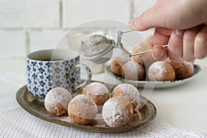 Vanilla krapfen doghnut with coffee. Rustic style.